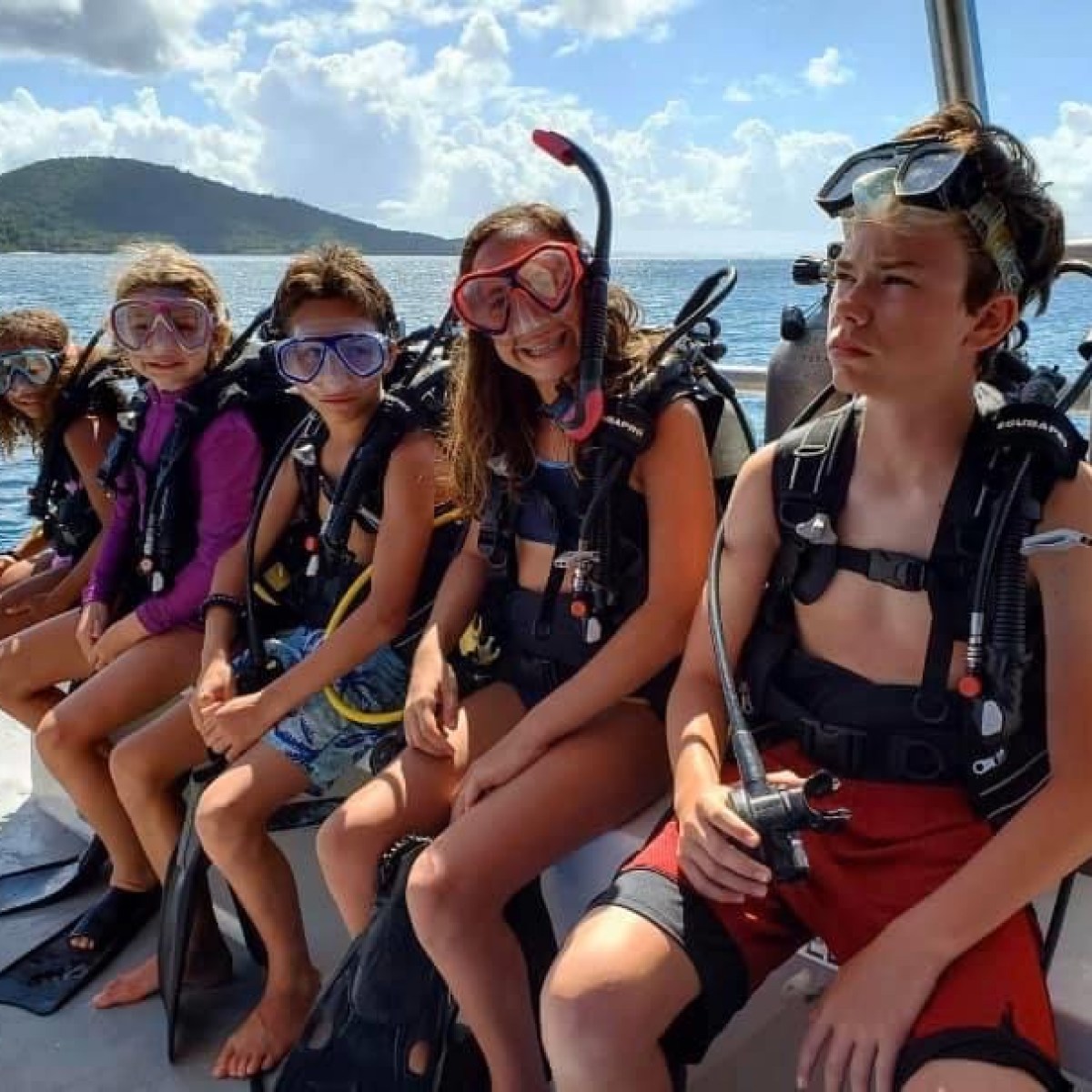 a group of people sitting at a beach